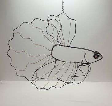Betta fish made out of black wire with copper wire for the inner details. The fish is also hung by a chain.