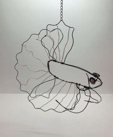 Betta fish made out of black wire with copper wire for the inner details. The fish is also hung by a chain.