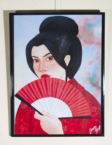 Geisha in red kimono holding a paper fan in front on her face. 