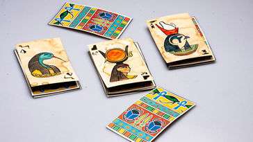 An assortment of playing cards decorated with Egyptian hieroglyphics